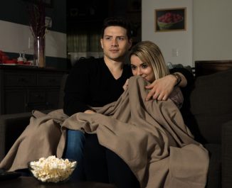 16 home date night ideas. Couple cuddling on the couch.