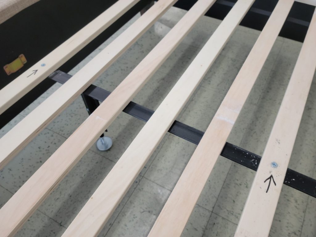 Platform Bed Girder Support With An Arrow Pointing At A Screw.