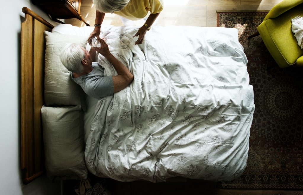Elderly man in one of the best mattresses for elderly seniors.