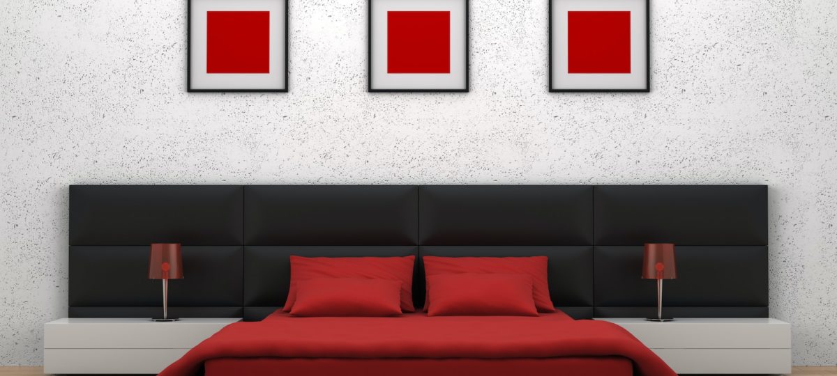 Modern bedroom with red, white, and black decor.