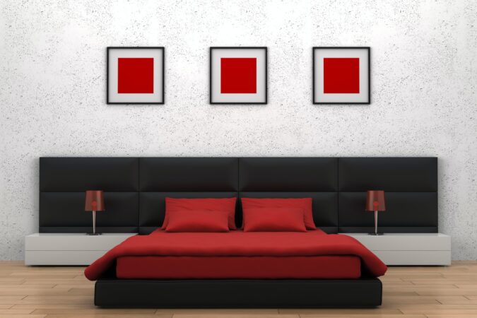 Modern bedroom with red, white, and black decor.