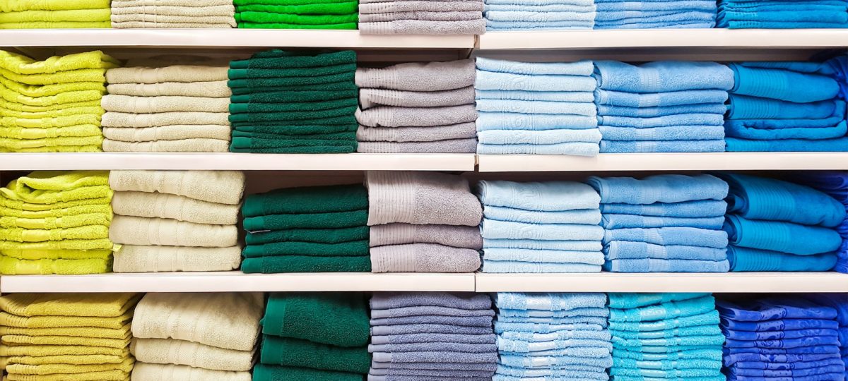 Colorful linen in a linen closet.
