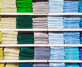 Colorful linen in a linen closet.