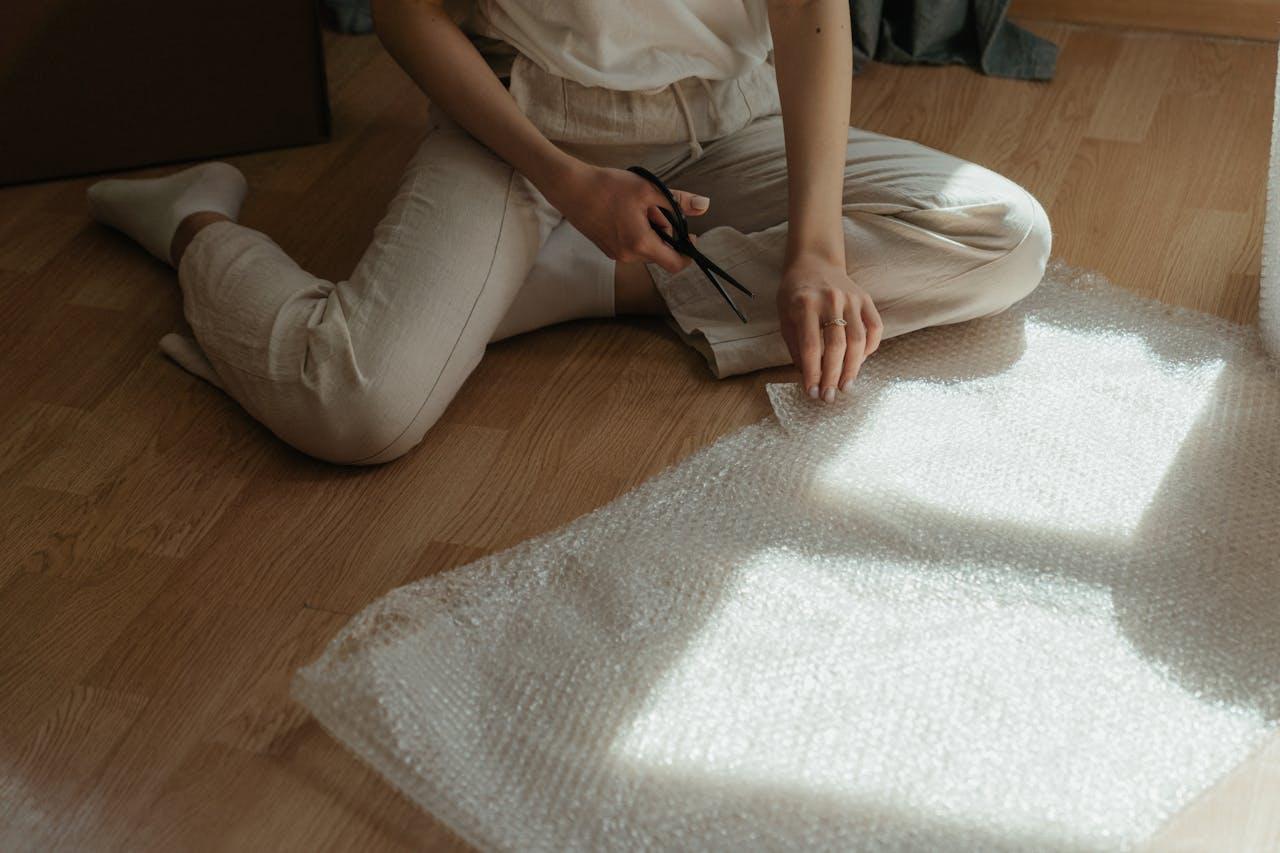 Woman cutting a bubble wrap sheet