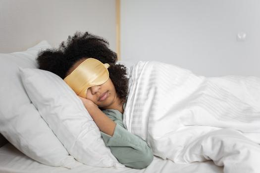 a woman sleeping with a sleeping mask.